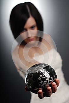 Woman holding a silver magic ball