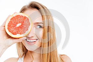 Woman holding slice of grapefruit