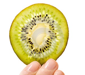 Woman holding slice of kiwi