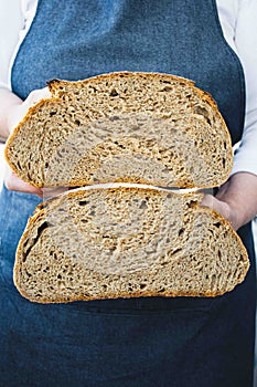 Woman holding a sliced sourdough bread