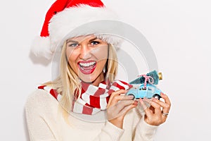 Woman holding small car with Christmas tree