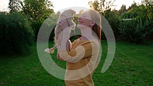 Woman holding a small cute Chihuahua puppy at sunset.