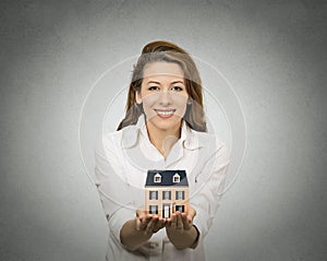 Woman holding small model of house