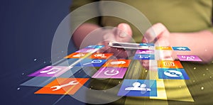 Woman holding smart phone with colorful application icons