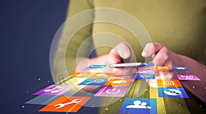 Woman holding smart phone with colorful application icons