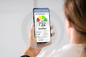 Woman Holding Smart Phone Showing Credit Score Application