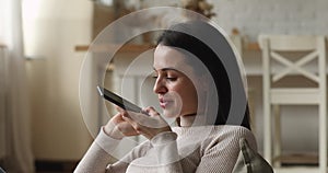 Woman holding smartphone lead personal conversation on the speakerphone