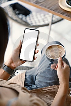 Woman holding smartphone showing white screen at morning