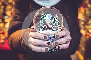 Woman holding snow globe on the Christmas fair
