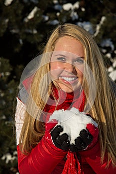 Woman holding snow pile in hands