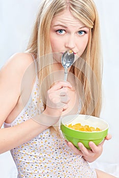 Woman holding spoon and corn flakes