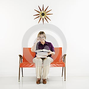 Woman holding stack of books.