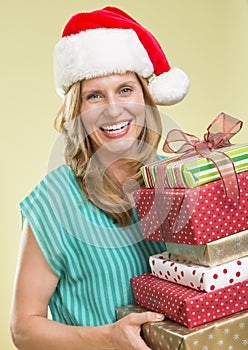 Woman Holding Stack Of Christmas Presents