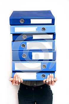 Woman holding stack of folders