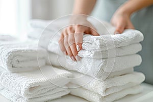 A woman is holding a stack of white towels by AI generated image