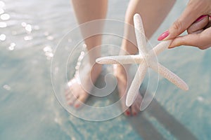 Woman holding starfish at the beach