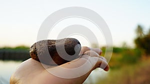 Woman holding stone in hand, integration of working life, burdens and women`s power.