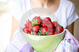 Woman holding strawberries