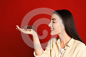 Woman holding striped knee tarantula on background. Exotic pet