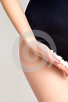 Woman holding sugar cubes on bikini zone, the concept of intimate depilation, problems of intimate hygiene.