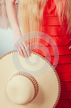 Woman holding sun hat