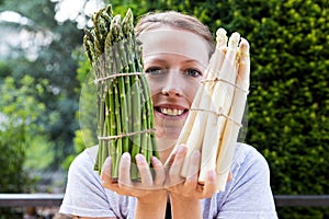 Woman is holding sundry asparagus