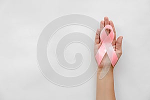 Woman holding symbolic ribbon of breast