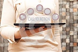 Woman holding tablet with Call To Action. Business photo showcasing exhortation do something in order achieve aim with problem.