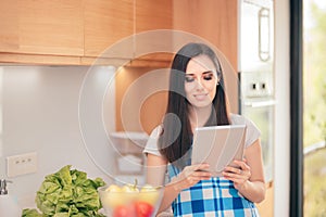 Woman Holding Tablet Pc Looking for Recipes Online