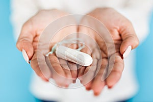 Woman holding a tampon photo