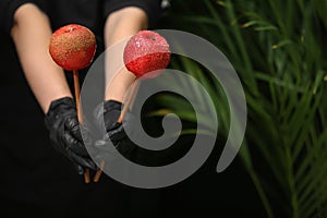 Woman holding tasty candy apples