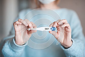 Woman holding thermometer