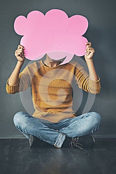 Woman holding thought bubble, chat or speech board for voicing opinions, chatting on social media or sharing ideas photo