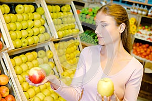 Woman holding three apples in hands