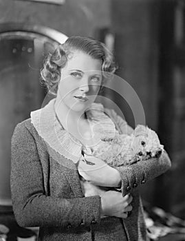 Woman holding tiny puppy