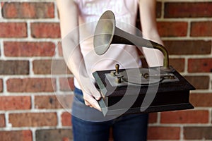 Woman holding a traditional gramaphone replica