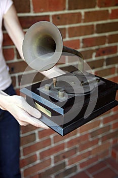 Woman holding a traditional grammaphone replica