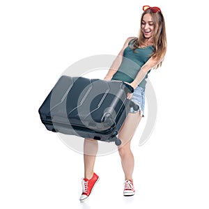 Woman holding travel suitcase goes walking