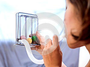Woman holding triflow and deep breathing photo