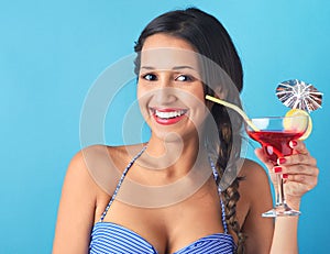 Woman holding tropical cocktail with decorative umbrella