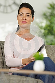 woman holding tv remote control