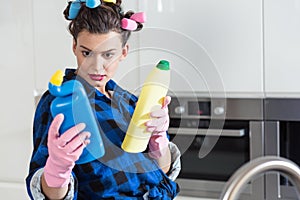 Woman holding two bottles of cleaners