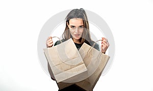 Woman is holding two grocery shopping bags on white background. Paper bags in hands. Isolated background.