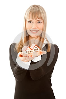 Woman holding two house (focus on house)