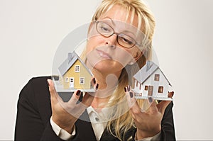 Woman Holding Two Houses