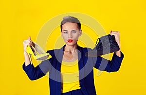 Woman holding two pairs of shoes