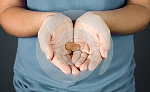 A Woman Holding Two Pennies