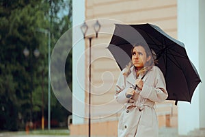 Woman Holding an Umbrella feeling Cold During Spring Season