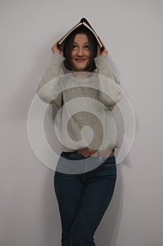 a woman holding up a book in front of her face