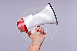 Woman holding up a loud hailer or megaphone photo